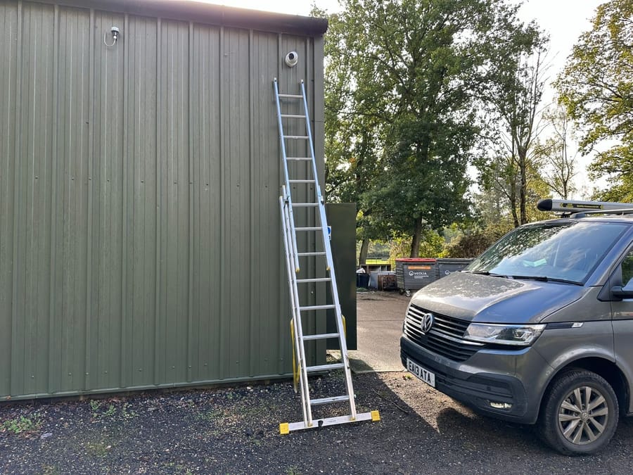 CCTV camera on a steel-clad building with the EA Data van parked alongside