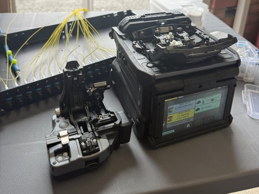 Fujikura fusion splicer and cleaver set up on site with the EA Data van outside