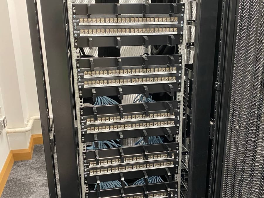 Floor-standing rack filled with Excel patch panels and cable management