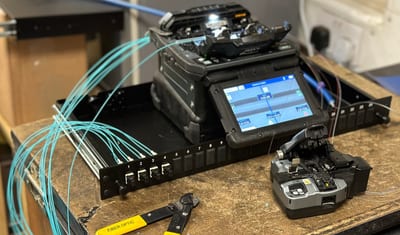 Fusion splicer and fibre patch panel on an EA Data workbench